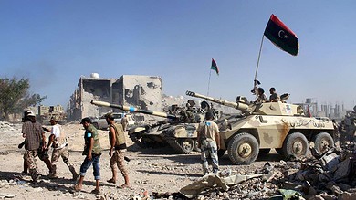 Tank and armed personnel in a conflict zone in Sirt, Libya, related to recent security operations ag.