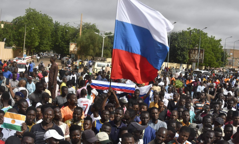 Demonstrators raise the Russian flag during an Independence Day demonstration in Niamey, Niger's capital, on August 3, 2023.