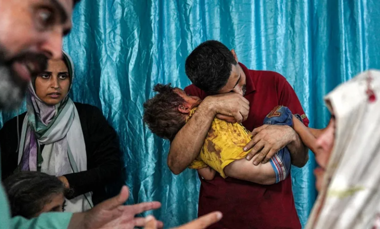 A man embraces a child injured as a result of the Israeli bombing in Deir al-Balah in the central Gaza Strip. June 4, 2024