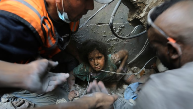 Palestinians try to pull a young girl out of the rubble of a building that was destroyed by Israeli airstrikes in the Jabalia refugee camp, in the northern Gaza Strip