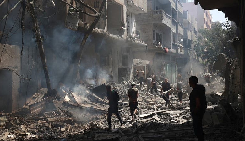 Palestinians walk on the rubble of destroyed buildings following an operation by the Israeli Special Forces in the Nuseirat camp, in the central Gaza Strip on June 8, 2024