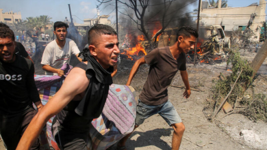 Palestinians carry a victim of an Israeli raid on a camp in the Al-Mawasi area in Khan Yunis, south of the Gaza Strip. July 13, 2024