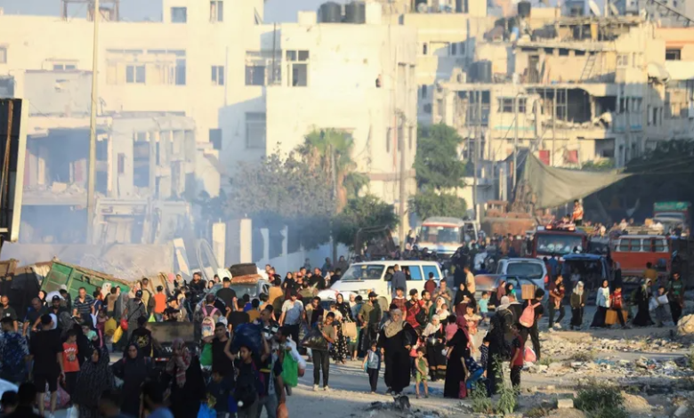 Palestinians carry their belongings and leave the eastern part of Gaza City after the Israeli army ordered them to evacuate. July 7, 2024