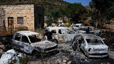 Palestinians check burned vehicles after Israeli settlers attack near Ramallah in the Israeli-occupied West Bank, June 21,2023.