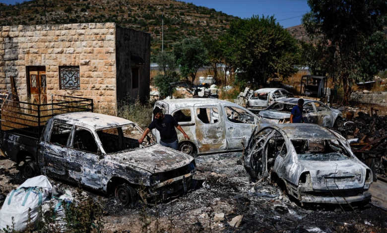 Palestinians check burned vehicles after Israeli settlers attack near Ramallah in the Israeli-occupied West Bank, June 21,2023.