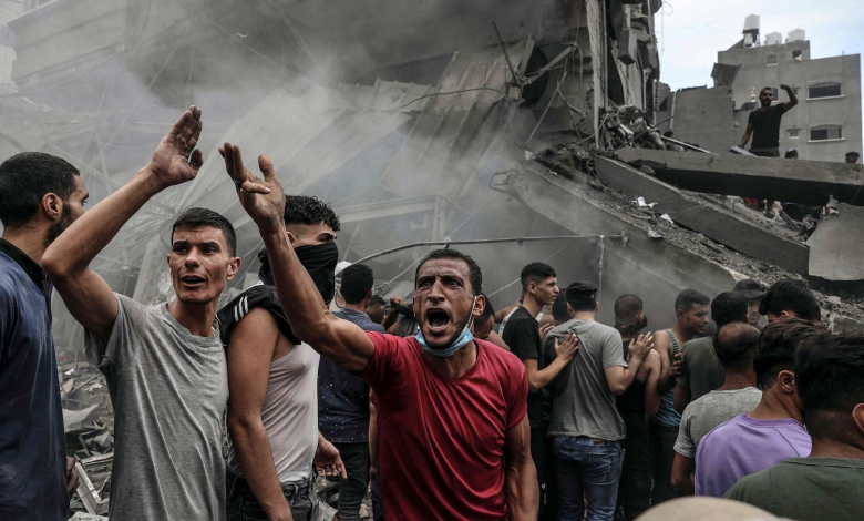 Palestinians search for survivors after an Israeli airstrike on buildings in the refugee camp of Jabalia in the Gaza Strip, Oct. 9, 2023.