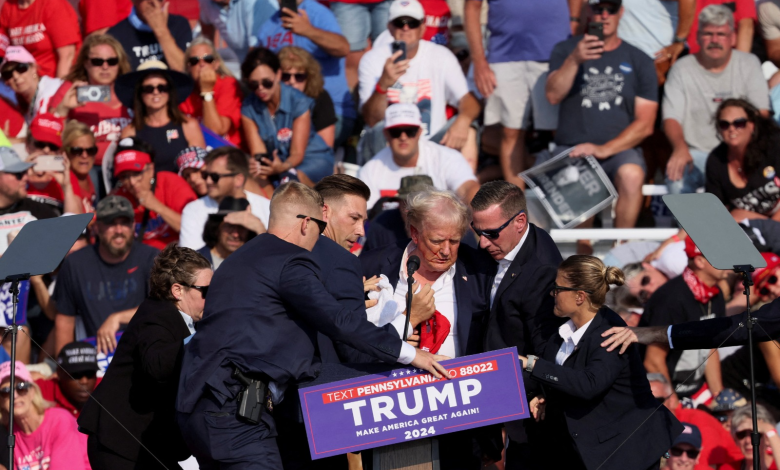 Secret Service members surround former US President Donald Trump after he was shot and wounded during an election rally in Pennsylvania. July 13, 2024