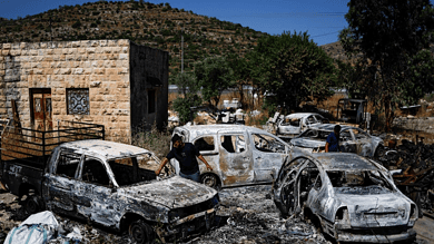 Palestinians check burned vehicles after Israeli settlers attack near Ramallah in the Israeli-occupied West Bank, June 21,2023.