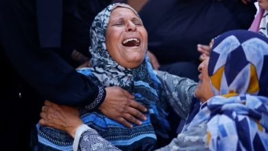 A Palestinian woman cries at Nasser Hospital after Israeli airstrikes killed her relatives in Khan Younis, southern Gaza Strip, August 13, 2024