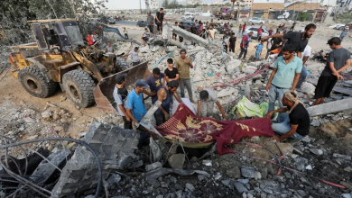 Palestinians search for survivors or injured people amid the rubble following Israeli shelling in central Gaza, August 17, 2024.