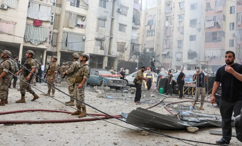 People and army personnel inspect the site of an airstrike in the southern suburbs of Beirut, Lebanon, September 20, 2024