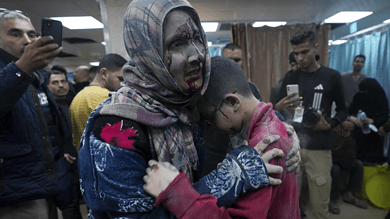 Palestinians wounded in the Israeli bombardment of the Gaza Strip are brought to the hospital in Deir al Balah on Friday, Dec. 8, 2023