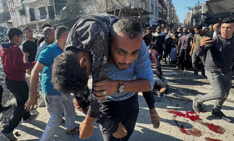 Palestinians try to help retrieve the wounded and bodies of victims following an Israeli airstrike on Beit Lahia in the Gaza Strip, October 30, 2024.