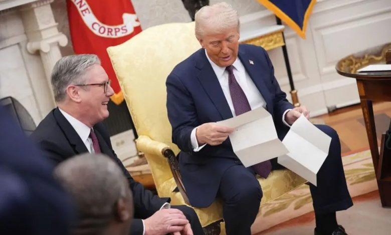 U.S. President Donald Trump holds a letter from Britain's King Charles during a meeting with British Prime Minister Keir Starmer in the Oval Office of the White House in Washington, D.C., U.S., February 27, 2025.