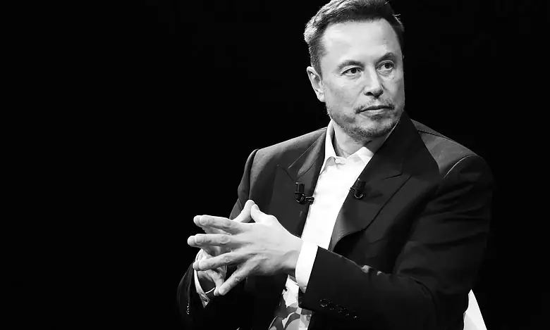 Male speaker in a suit during a discussion or interview on stage.