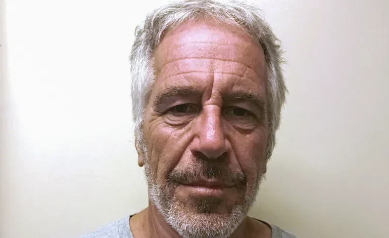 Man with gray hair and beard, looking directly at the camera, neutral expression.