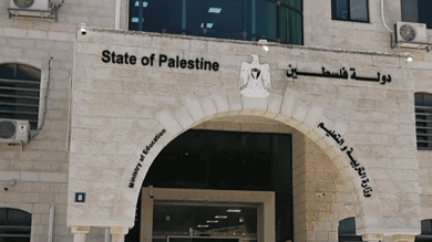 Palestinian government building with national emblem and Arabic signage.