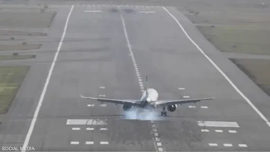 Aircraft taking off from runway at airport.