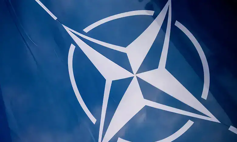 NATO flag flying, symbolizing military readiness for Arctic reconnaissance mission.