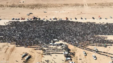 Explosion site in Libya with a large crowd of people and vehicles.