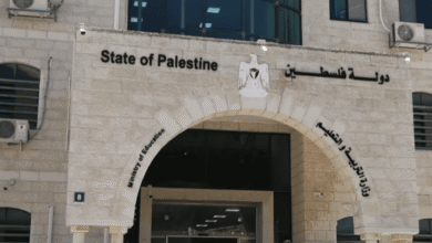 Palestinian government building with national emblem and Arabic signage.