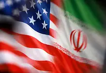 US and Iran flags close-up, symbolizing diplomatic relations.