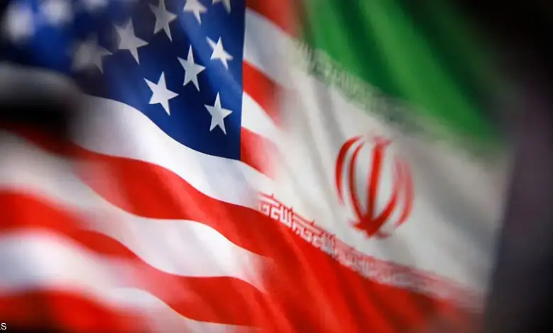US and Iran flags close-up, symbolizing diplomatic relations.