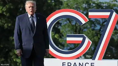 Donald Trump speaking at G7 summit with G7 logo in background.